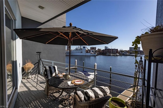 view of dock featuring a water view and a balcony