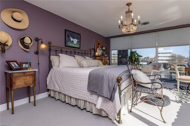 bedroom featuring baseboards, carpet flooring, and a notable chandelier