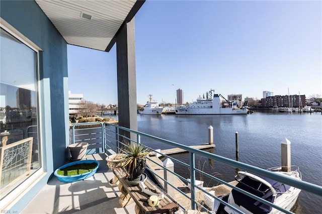 balcony featuring a water view and a view of city