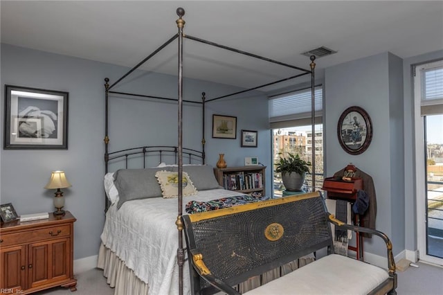 bedroom with baseboards, visible vents, carpet flooring, and multiple windows