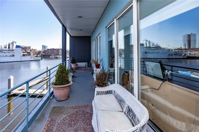 balcony featuring a view of city and a water view