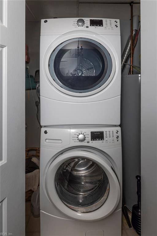 laundry room with stacked washer and dryer and laundry area