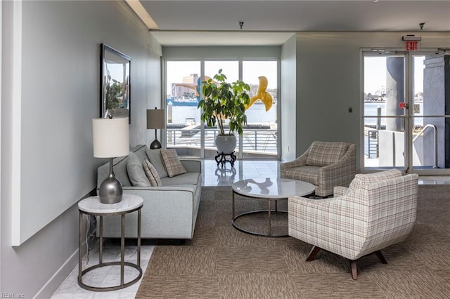 living room with a water view and baseboards