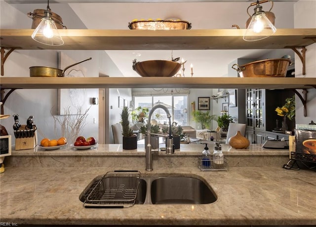 kitchen with decorative light fixtures and light stone countertops