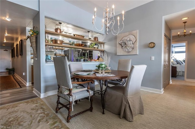 dining space with baseboards and a chandelier