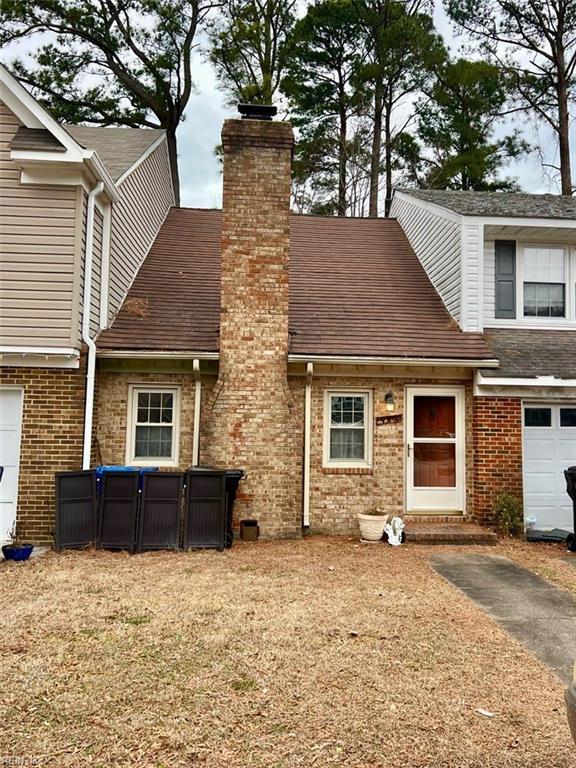 rear view of property with a garage