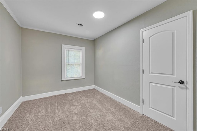 spare room featuring light colored carpet