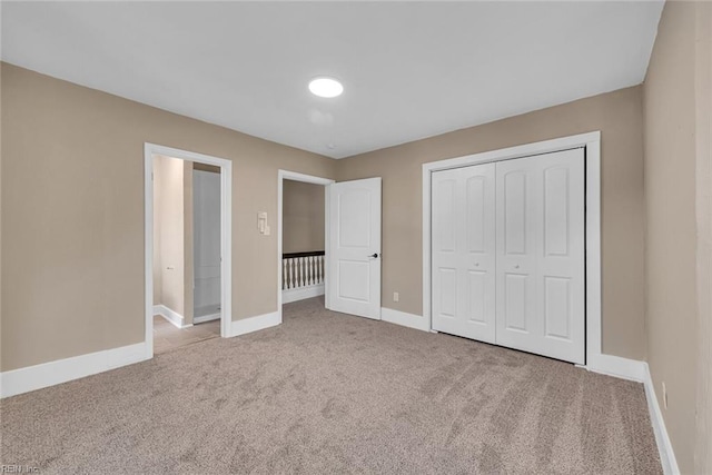 unfurnished bedroom with a closet and carpet