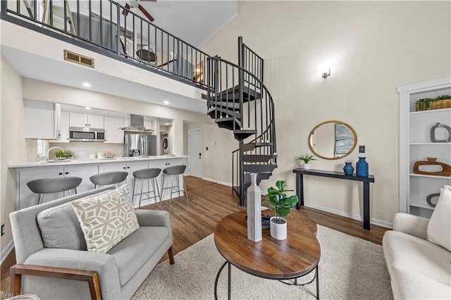 living room featuring dark hardwood / wood-style floors and a high ceiling