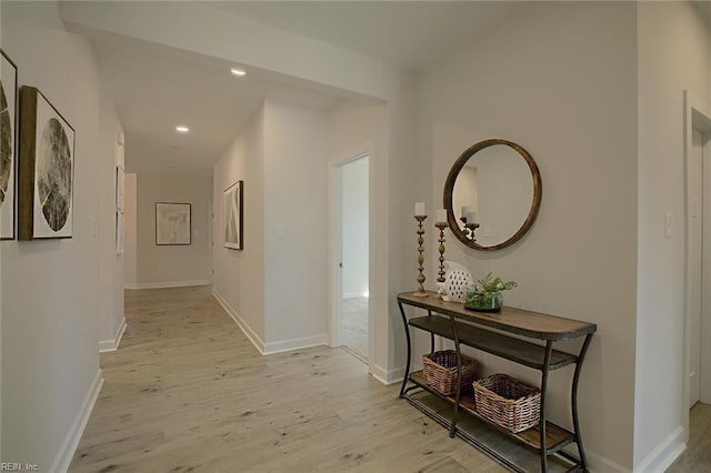 hallway with light hardwood / wood-style floors