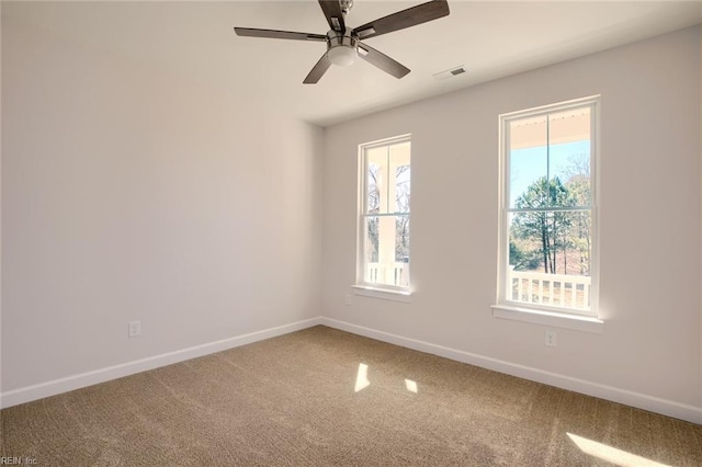 unfurnished room featuring ceiling fan and carpet floors