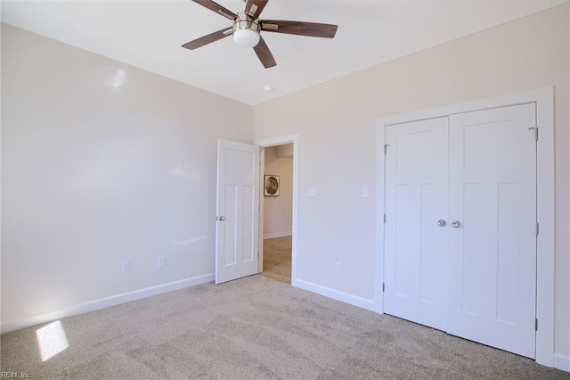 unfurnished bedroom with light carpet, ceiling fan, and a closet