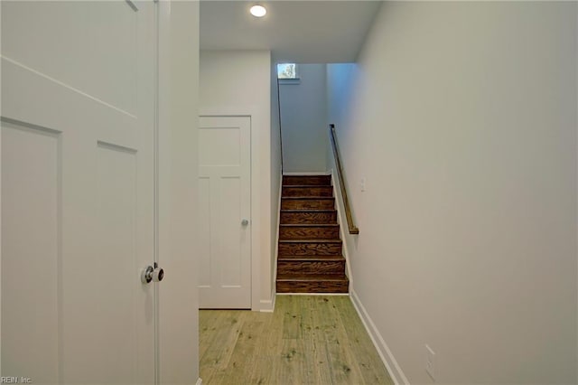 staircase with hardwood / wood-style floors