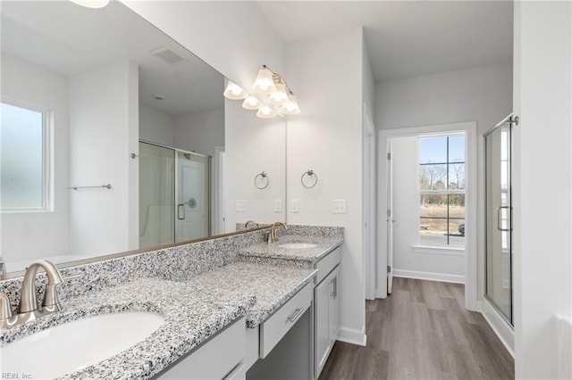 bathroom with vanity, hardwood / wood-style floors, and walk in shower