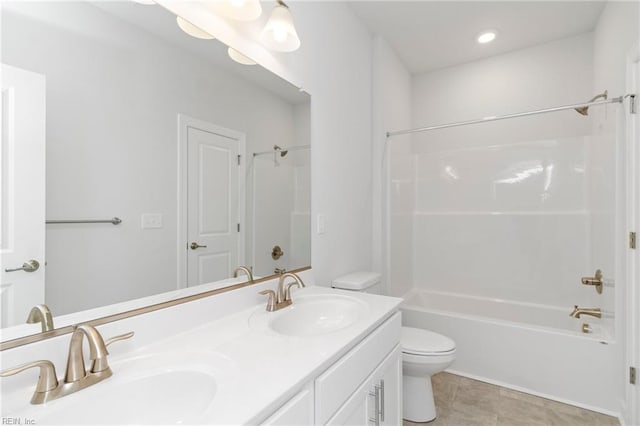 full bathroom with tile patterned flooring, vanity, washtub / shower combination, and toilet