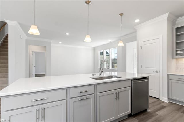 kitchen with gray cabinets, decorative light fixtures, an island with sink, sink, and stainless steel dishwasher