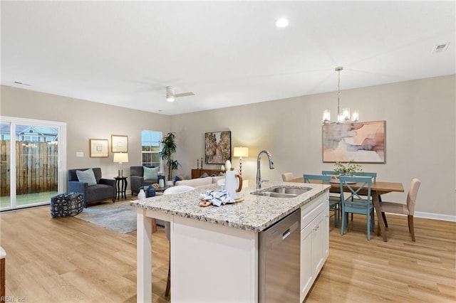 kitchen with sink, white cabinetry, hanging light fixtures, a center island with sink, and stainless steel dishwasher