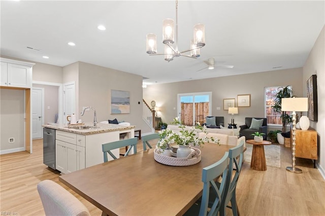 dining area with sink, light hardwood / wood-style floors, and ceiling fan