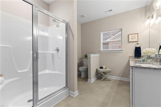 bathroom featuring walk in shower, vanity, and toilet