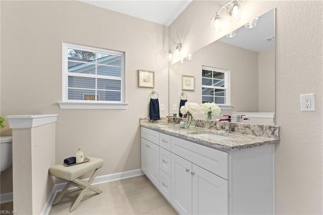 bathroom featuring vanity and toilet