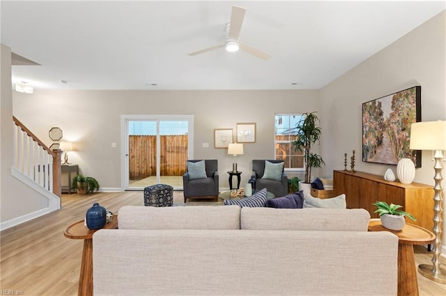 living room featuring ceiling fan and light hardwood / wood-style flooring