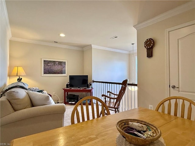 carpeted dining room featuring ornamental molding