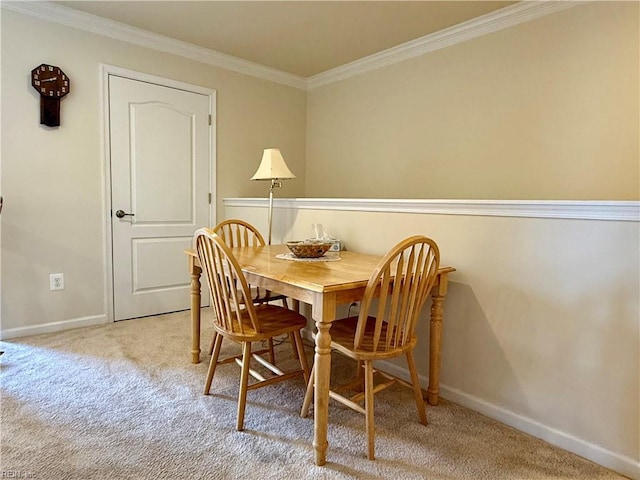 carpeted dining area featuring ornamental molding