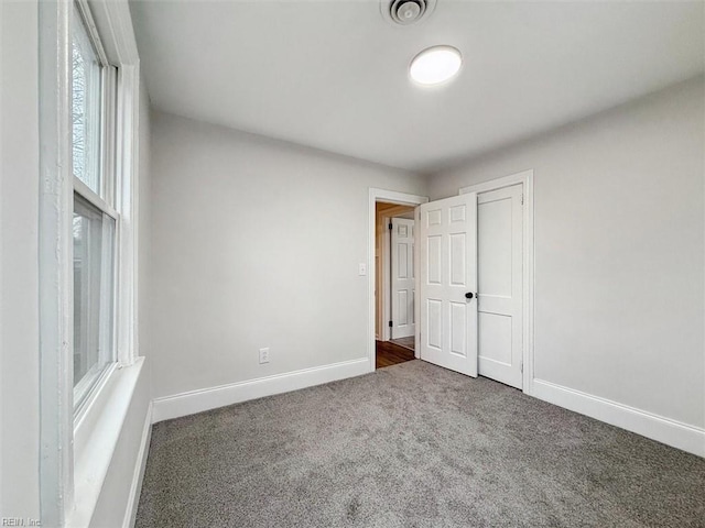 428 Hampton Roads Ave, Hampton, VA 23661 - unfurnished bedroom with dark carpet and a closet
