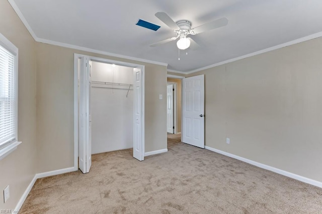 unfurnished bedroom with light carpet, crown molding, a closet, and ceiling fan