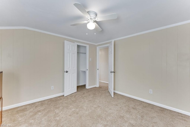 unfurnished bedroom featuring light carpet, ornamental molding, and ceiling fan