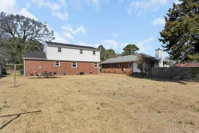 back of house with a lawn