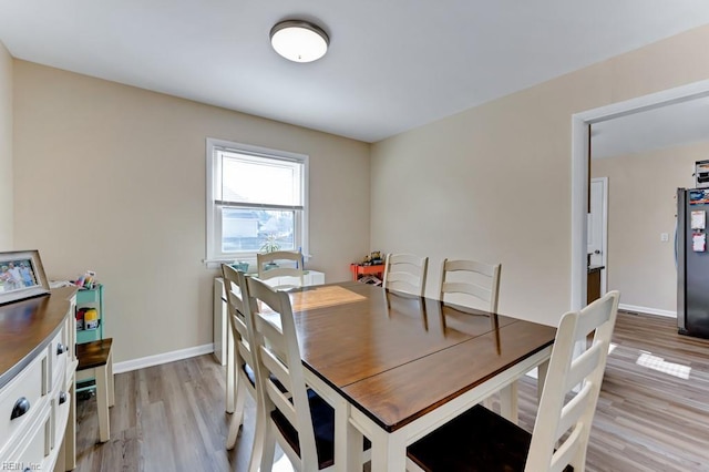 dining area featuring light wood-type flooring