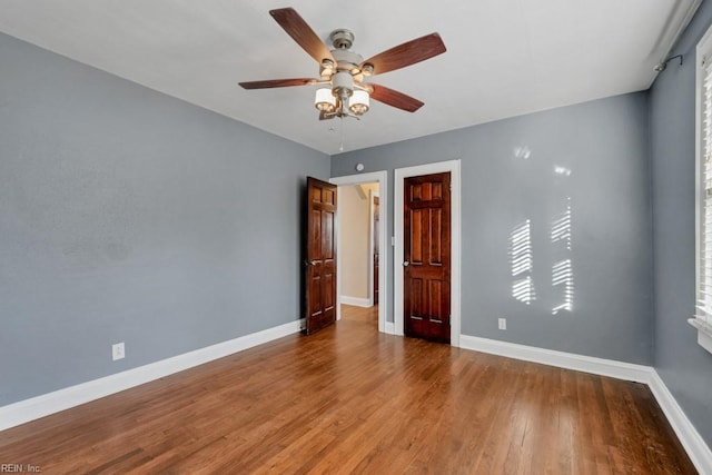 unfurnished room with wood-type flooring and ceiling fan