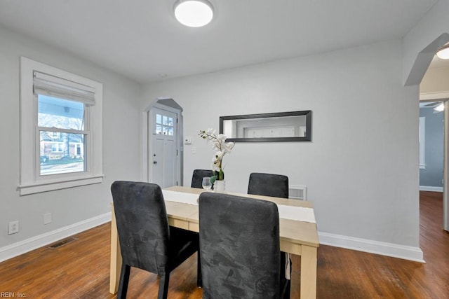 dining area with dark wood-type flooring