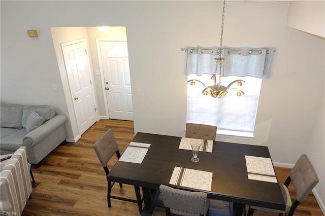 dining area featuring an inviting chandelier and dark hardwood / wood-style floors