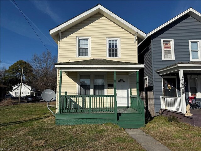 view of front of property with covered porch and a front yard