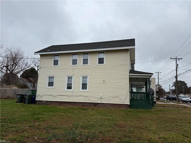 view of side of home featuring a lawn