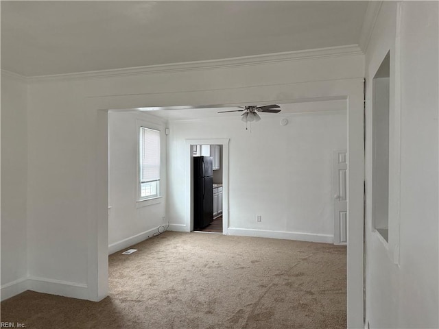 carpeted empty room with ornamental molding and ceiling fan