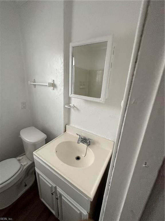 bathroom with vanity, hardwood / wood-style floors, and toilet