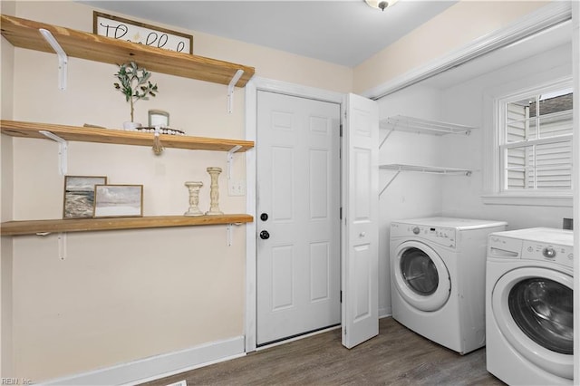 clothes washing area with dark hardwood / wood-style floors and separate washer and dryer