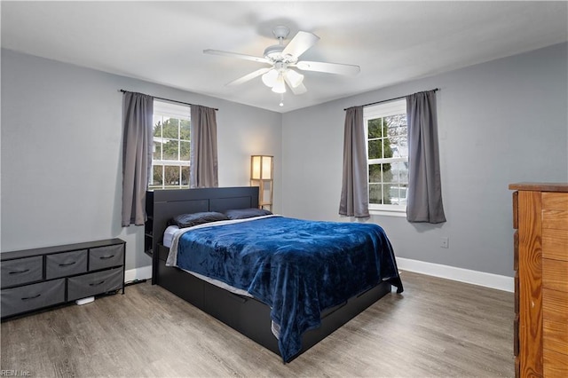 bedroom with hardwood / wood-style floors and ceiling fan