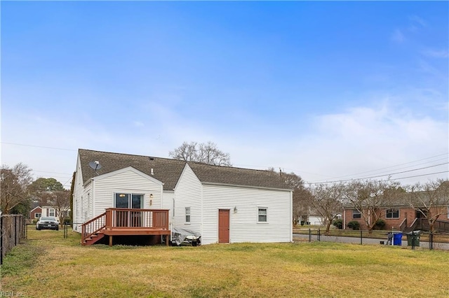 back of house with a deck and a lawn