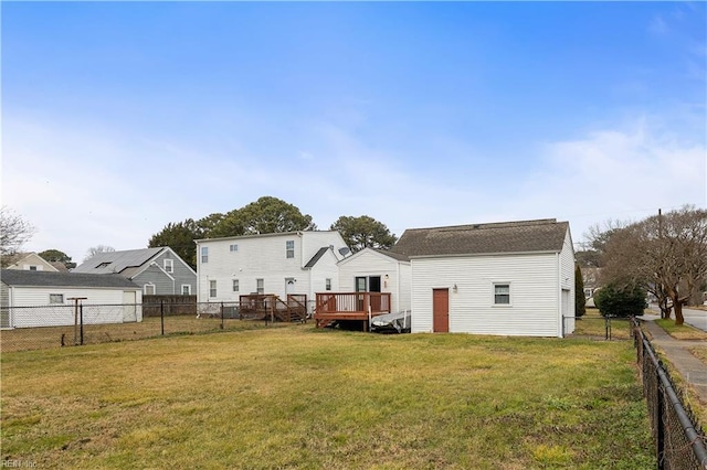 back of property featuring a yard and a deck