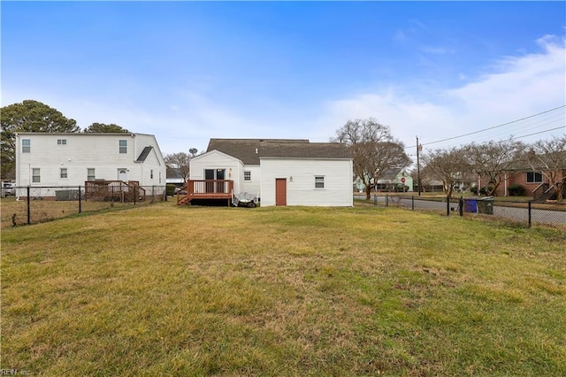 back of house with a wooden deck and a yard