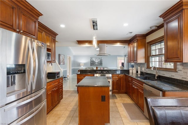 kitchen featuring pendant lighting, sink, island exhaust hood, a center island, and stainless steel appliances