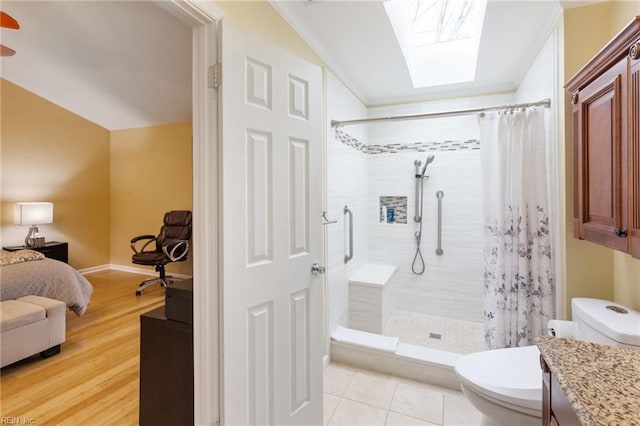 bathroom featuring vanity, hardwood / wood-style flooring, toilet, and a shower with shower curtain