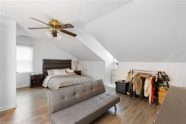 bedroom with hardwood / wood-style flooring, ceiling fan, and lofted ceiling