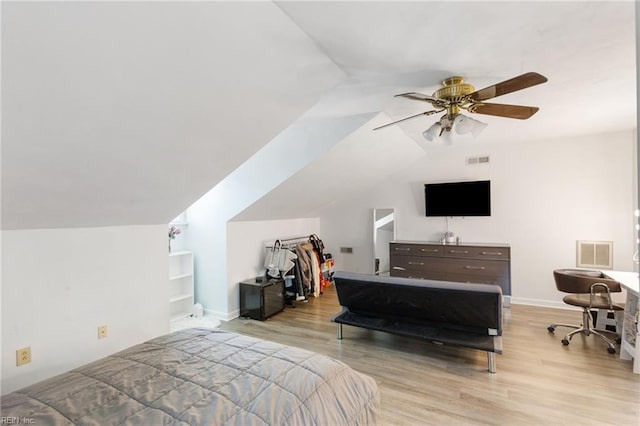 bedroom featuring ceiling fan, lofted ceiling, and light hardwood / wood-style flooring