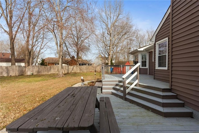 wooden terrace with a lawn