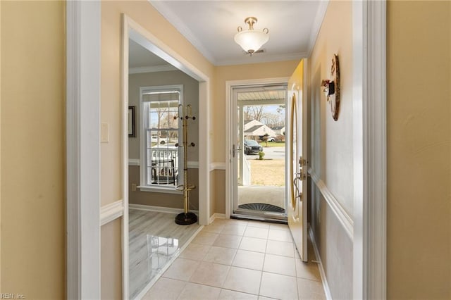 entryway with light tile patterned floors and crown molding